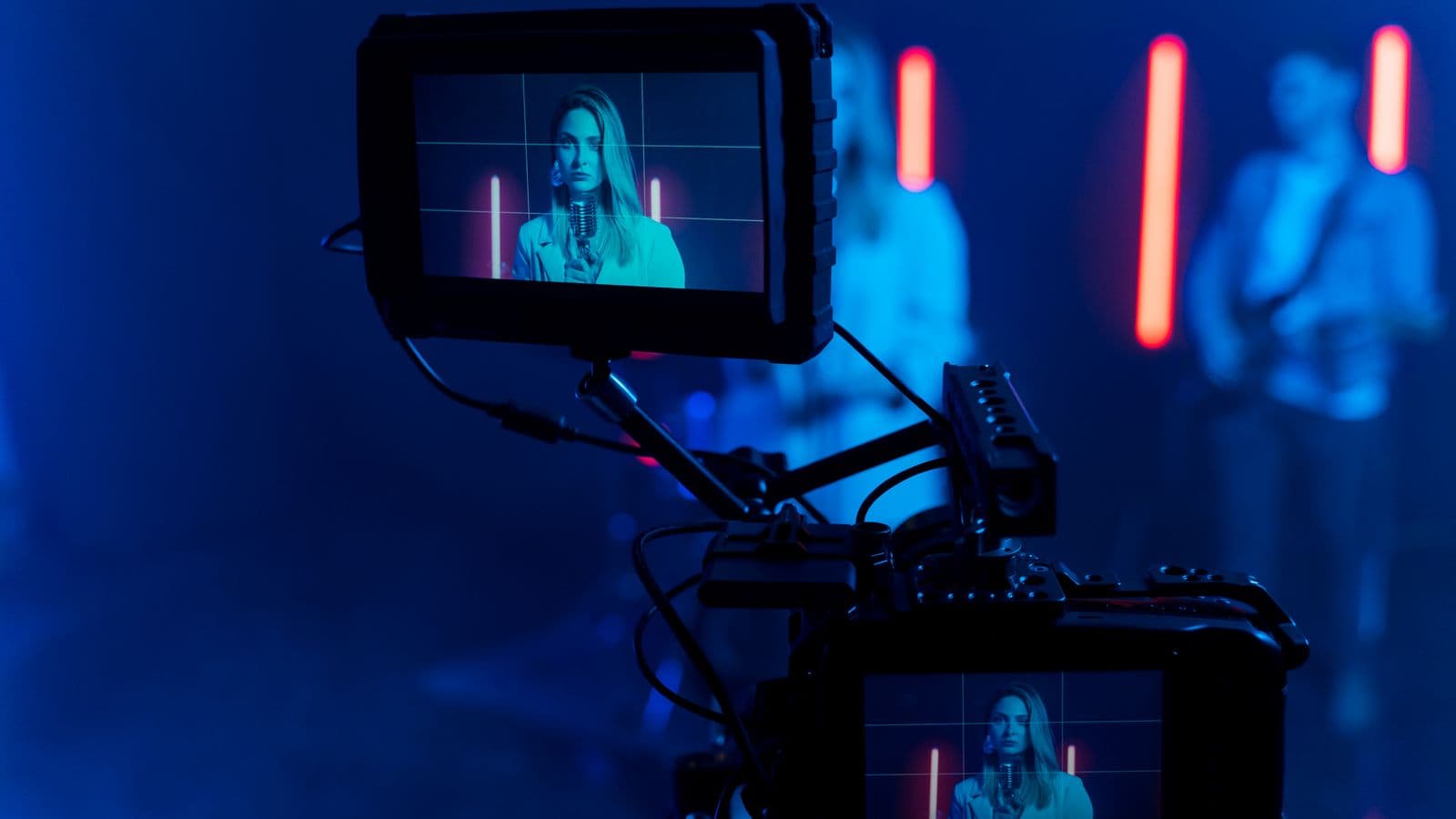 Music video set: a singer at a microphone, framed on the camera monitor